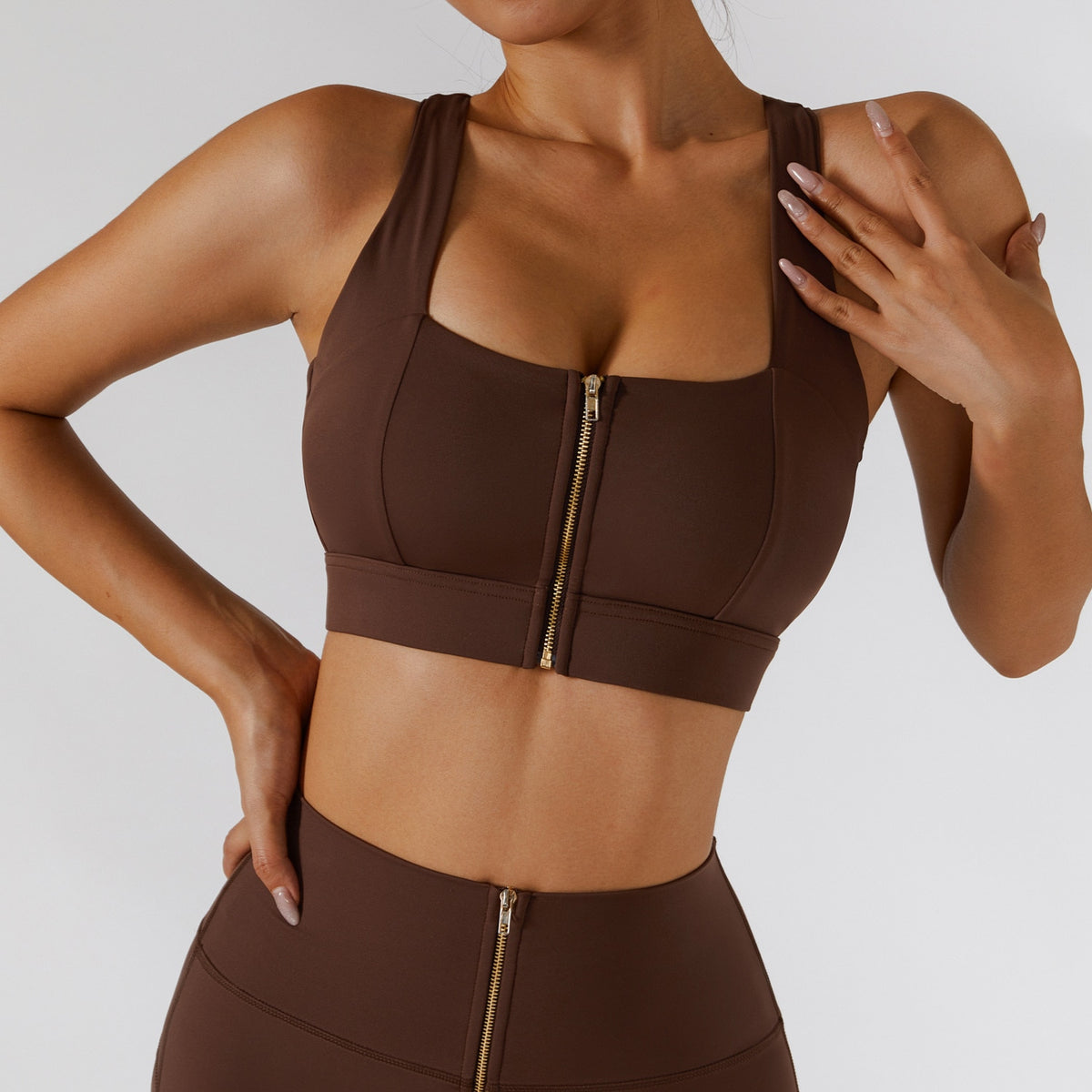 Two-piece women's yoga set by The Clothing Company Sydney featuring high waist leggings, a skirt, and a sporty zipper sports bra.