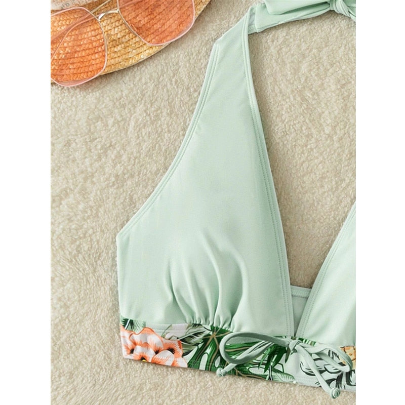 Two-piece swimsuit bikini top with lace print, high waist, halter neck, deep V-neck, and backless design by The Clothing Company Sydney.