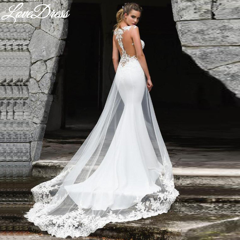 Elegant mermaid wedding dress by The Clothing Company Sydney with see-through back, sleeveless design, and lace appliques for brides.