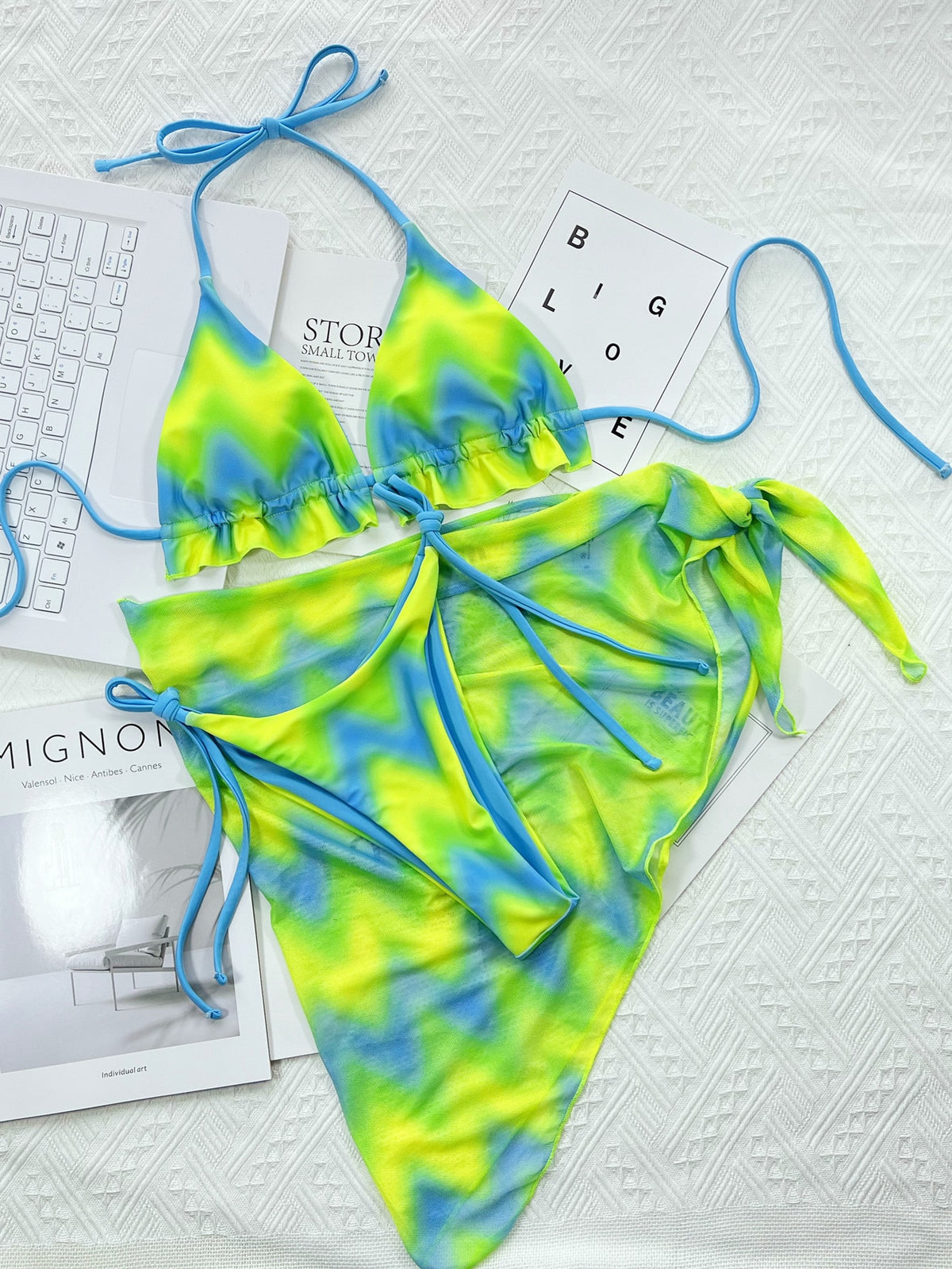 Colorful tie-dye women's bikini set with skirt, backless design, lace-up detail, and thong bottoms from The Clothing Company Sydney.