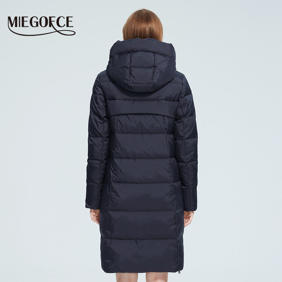 Women’s long cotton winter jacket by The Clothing Company Sydney with stand collar, hood, zipper, and pockets for warmth and windproof protection.