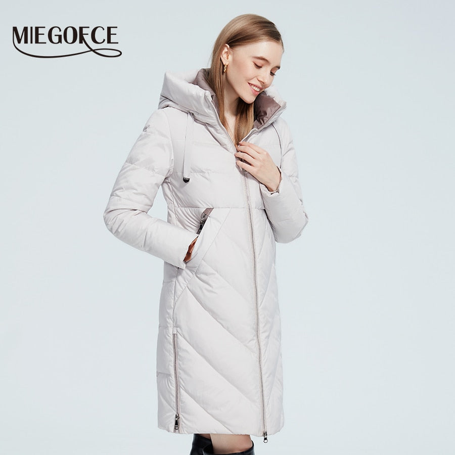 Women’s long cotton winter jacket with hood, stand collar, zipper closure, pockets, and windproof design by The Clothing Company Sydney.
