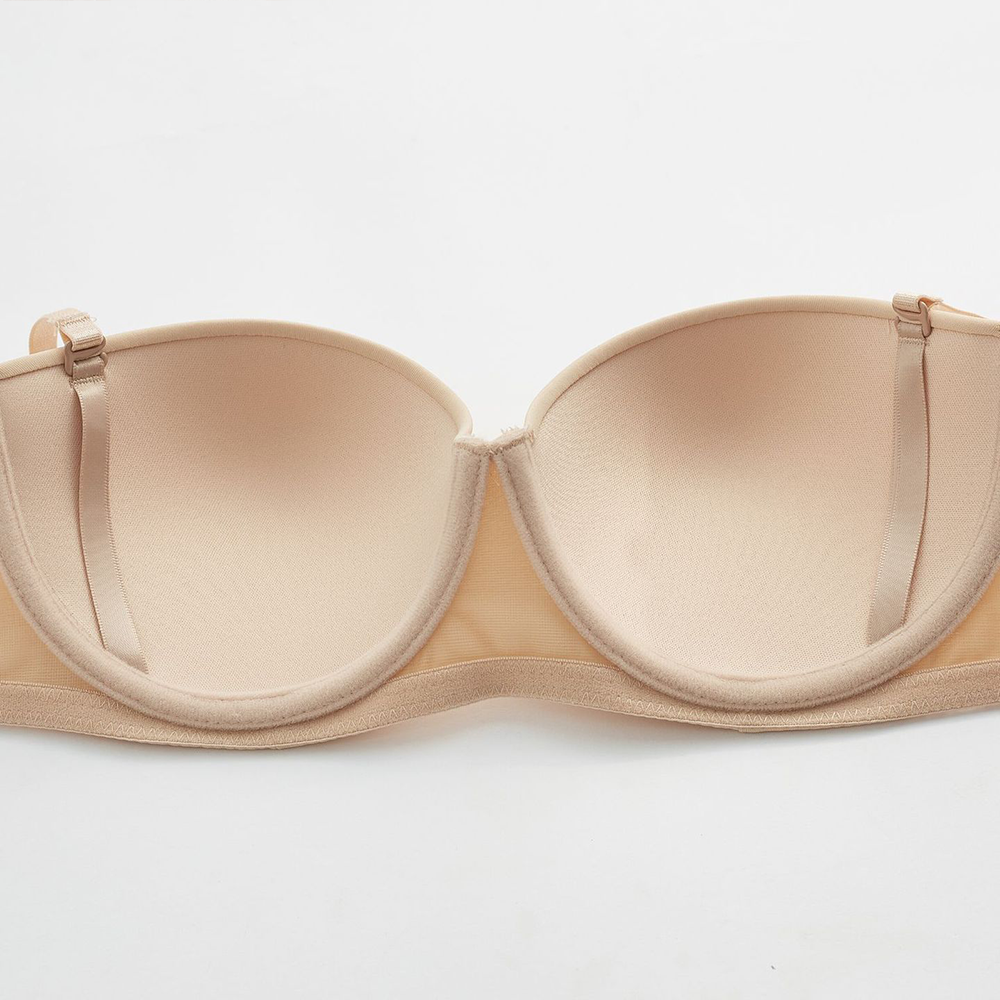 Seamless strapless bra by The Clothing Company Sydney, black 1/2 cup invisibly supporting lingerie with detachable shoulder straps.