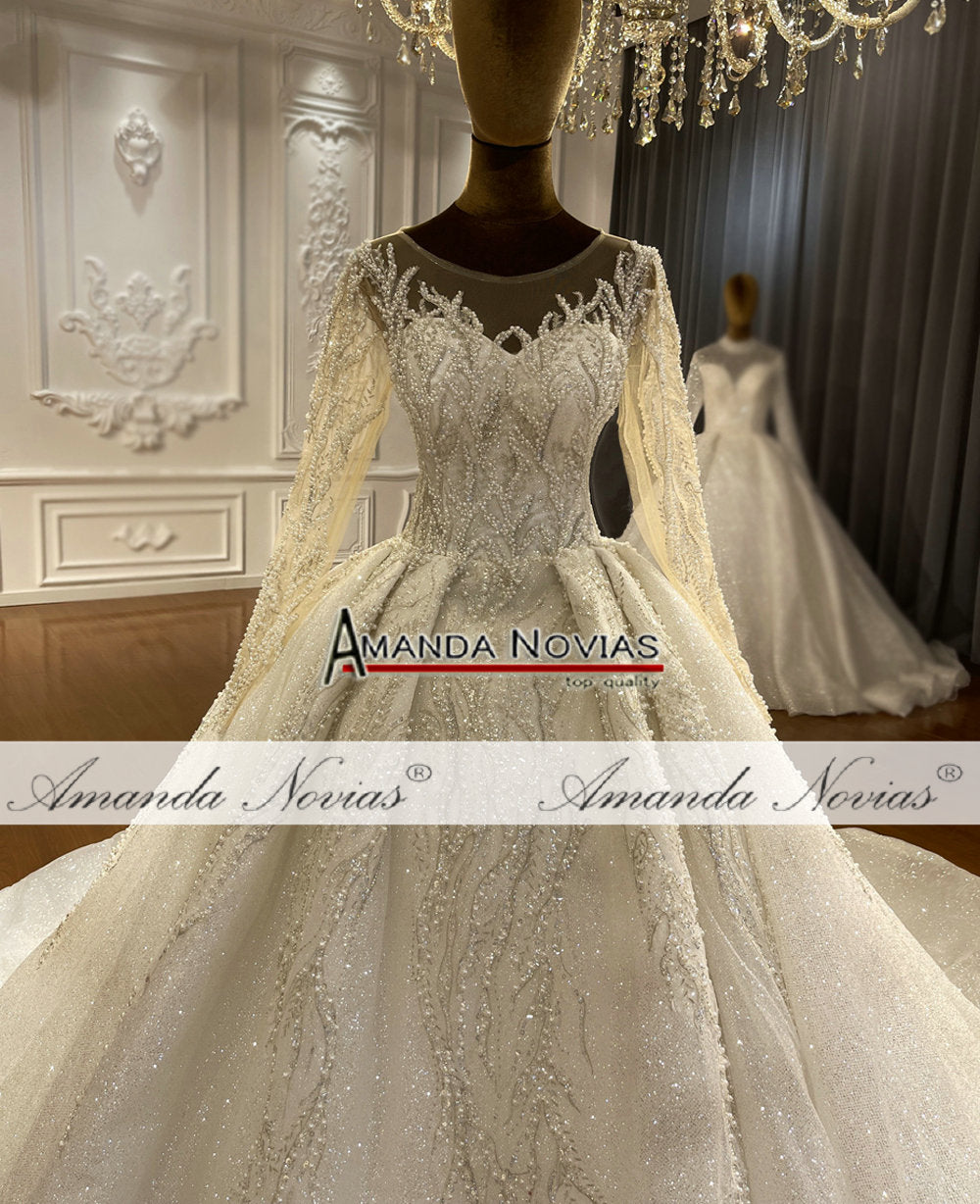 Elegant long sleeve ball gown wedding dress by The Clothing Company Sydney featuring a fitted bodice and flowing skirt.