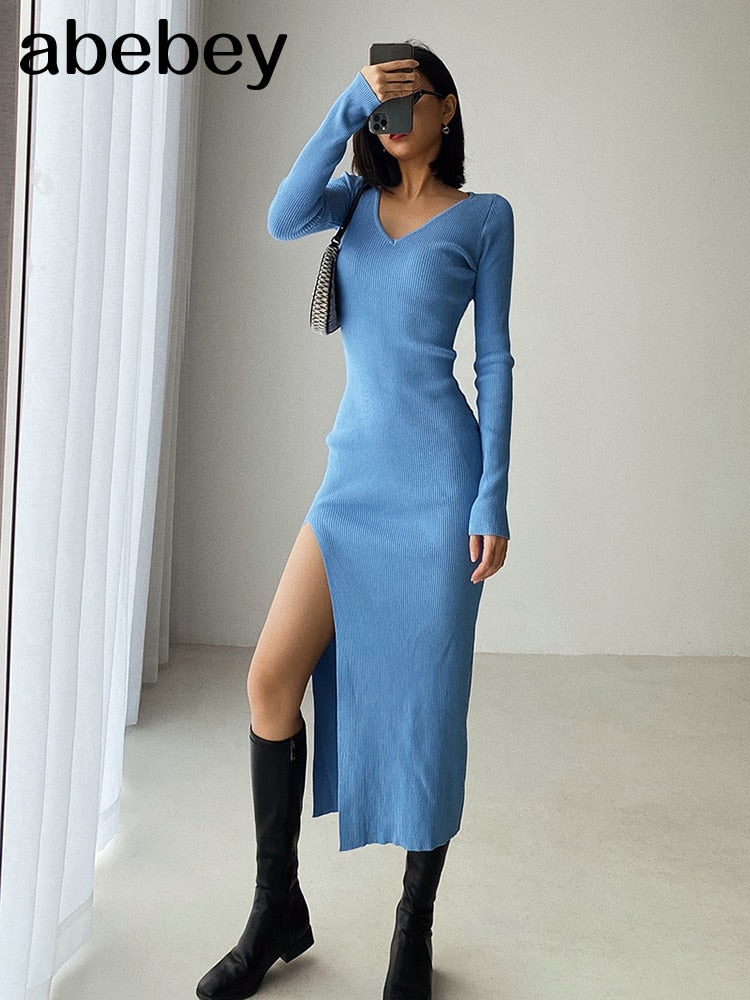 Slim fit long sleeve slit sweater dress by The Clothing Company Sydney, featuring over-the-knee length and hip-hugging knit design.