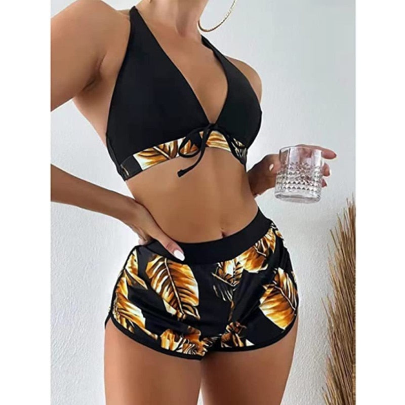 Two-piece bikini swimsuit from The Clothing Company Sydney featuring a high waist, lace print, halter neck, deep V-neck, and backless design.