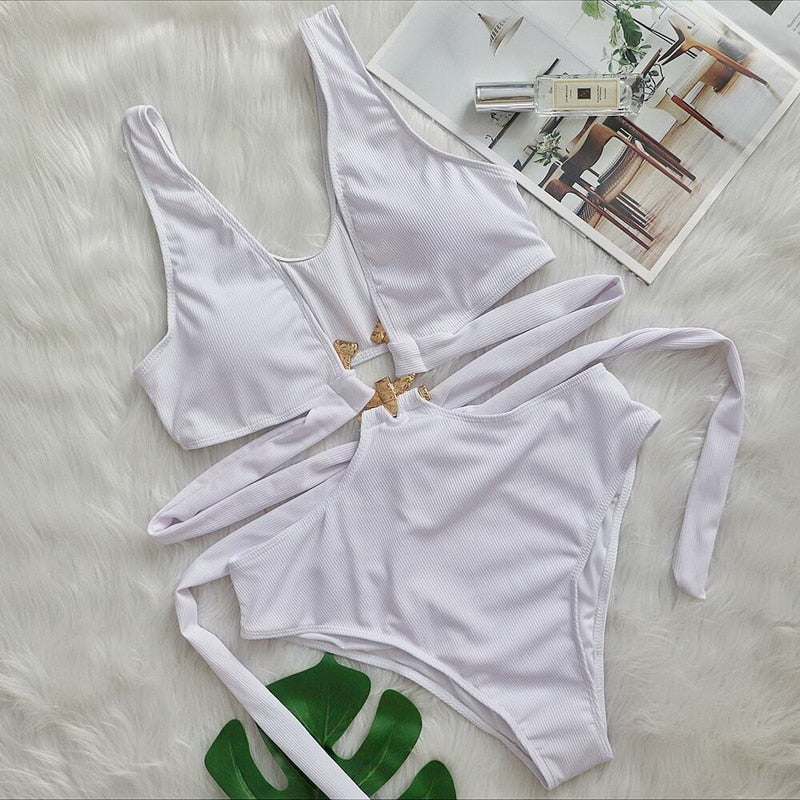 Hollow out floral one-piece swimsuit by The Clothing Company Sydney with cut-outs, metal decor, and push-up design for beachwear.