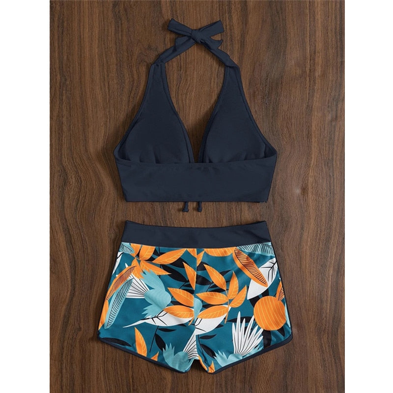 Two-piece bikini set by The Clothing Company Sydney featuring a lace print, high waist, halter neck, and backless push-up design.