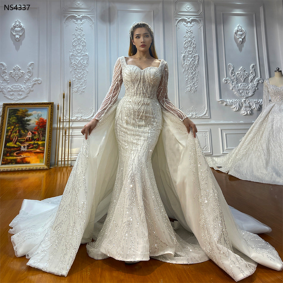 Elegant two-in-one luxury mermaid wedding gown by The Clothing Company Sydney, featuring intricate lace and flowing train.