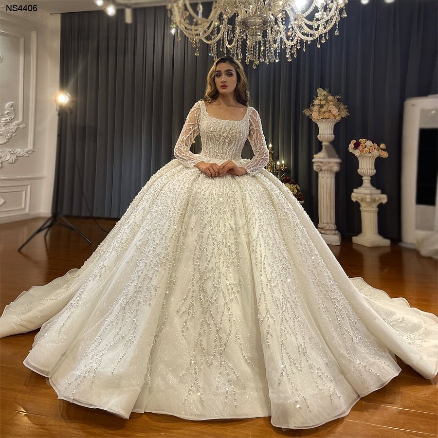 Long sleeve luxury beaded bridal wedding dress with intricate detailing, designed by The Clothing Company Sydney.