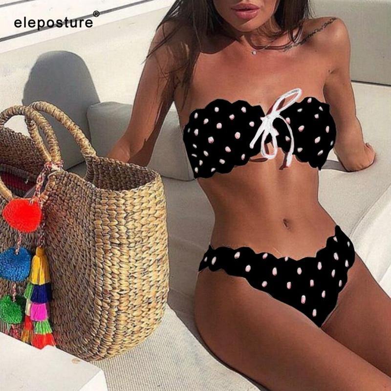 Polka dot two-piece swimsuit by The Clothing Company Sydney featuring floral accents, push-up top, Brazilian cut, and side tie bottoms.