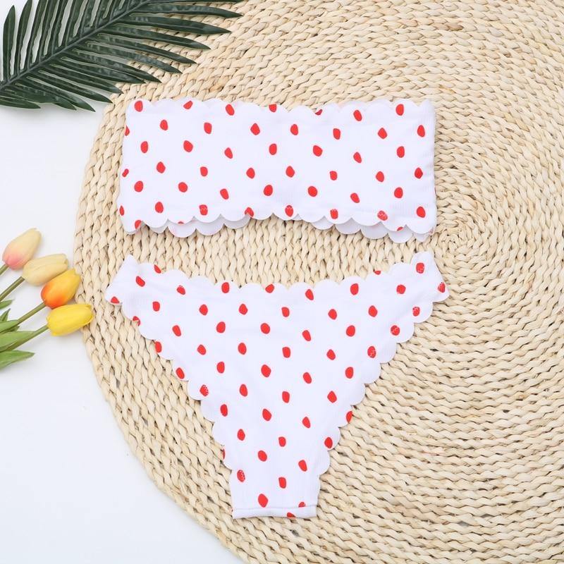 Polka dot two-piece swimsuit by The Clothing Company Sydney featuring floral side panels, push-up top, and Brazilian bikini style.