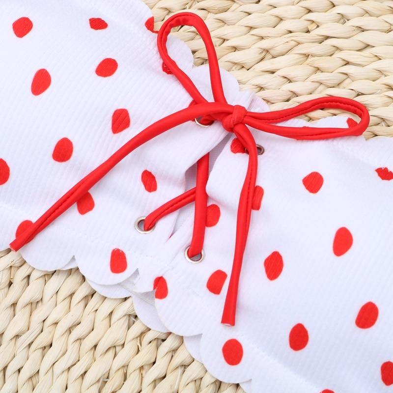 Polka dot two-piece swimsuit by The Clothing Company Sydney featuring floral accents, push-up style, Brazilian cut, and beach-ready design.
