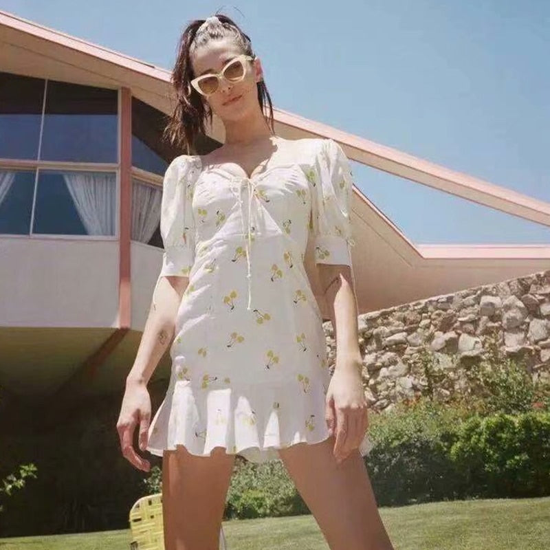 Vintage summer dress by The Clothing Company Sydney featuring white and yellow cherry print, puff sleeves, high waist, and silk-like fabric.