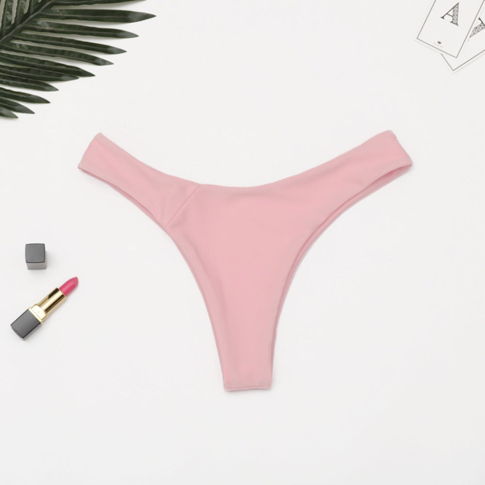 Brazilian women's thong swimsuit bottoms by The Clothing Company Sydney, low waist, solid color, cheeky bikini style, swim trunks