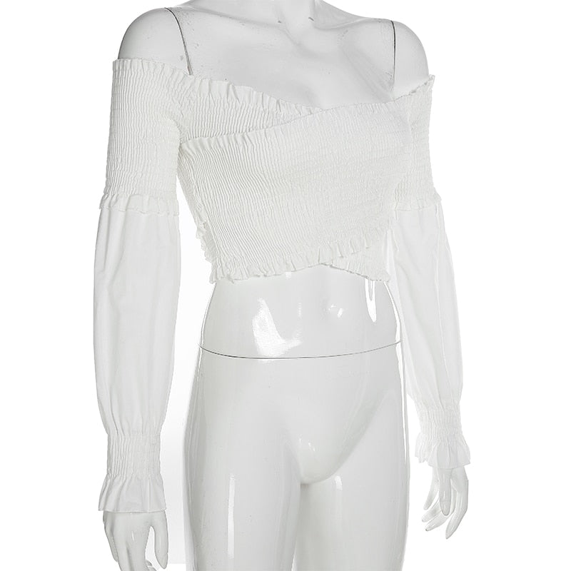 White long sleeve off-shoulder blouse with criss-cross details, chic smocking, and crop style from The Clothing Company Sydney.