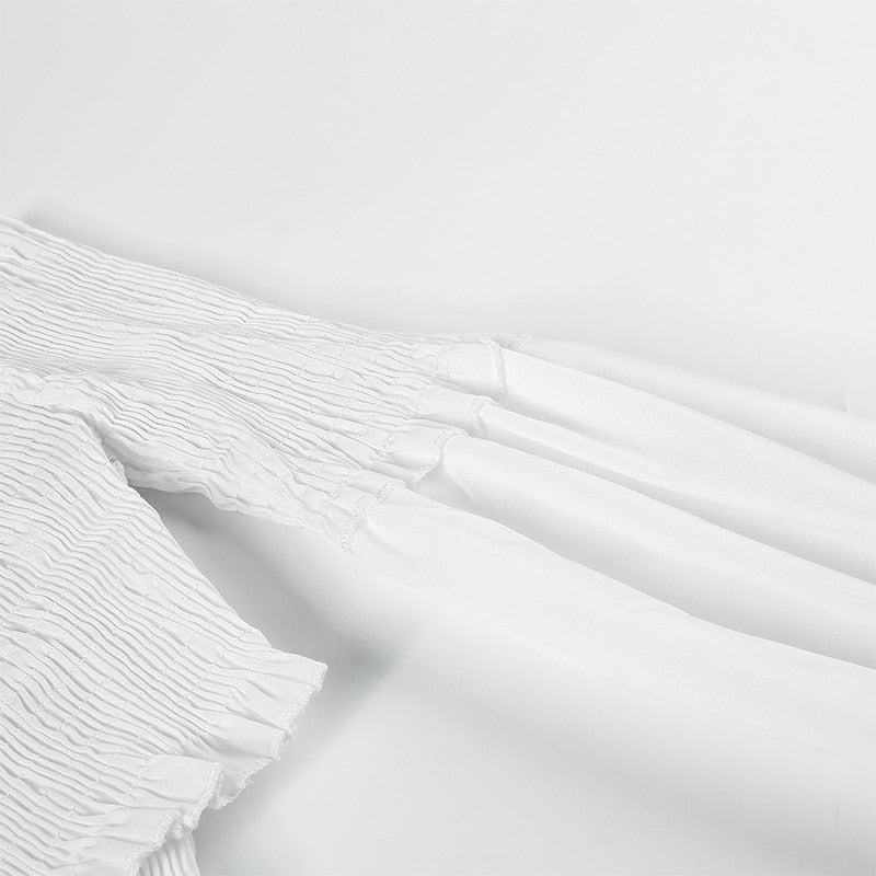 White long sleeve off-shoulder blouse with criss-cross detail, smocking, and crop style by The Clothing Company Sydney.