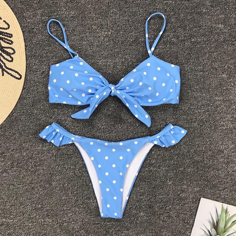 Polka dot two-piece swimsuit by The Clothing Company Sydney featuring floral side panels, push-up top, and Brazilian bikini bottom.
