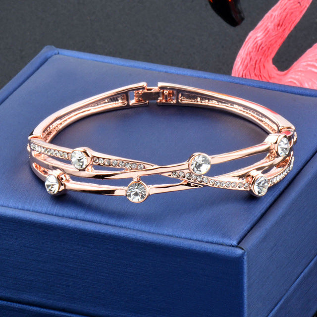 Rose gold and silver charm cubic zirconia hollow cuff bracelet with intricate design and sparkling accents.