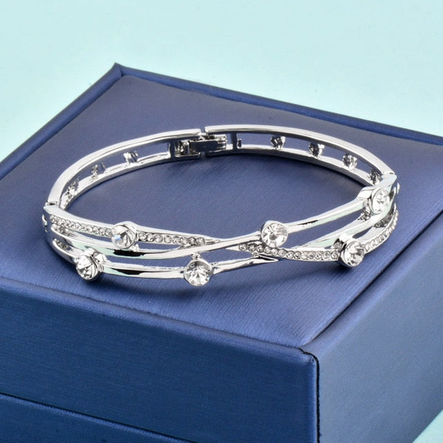 Hollow cubic zirconia charm bangle bracelet in rose gold and silver tones, featuring elegant jewelry design.