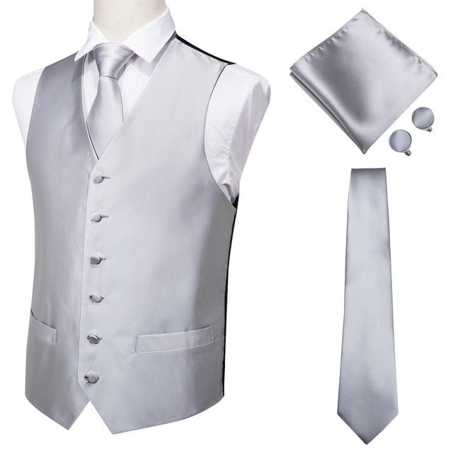 Four-piece navy paisley silk dress vest set with dark blue jacquard pattern, including tie, cufflinks, pocket square, and waistcoat.