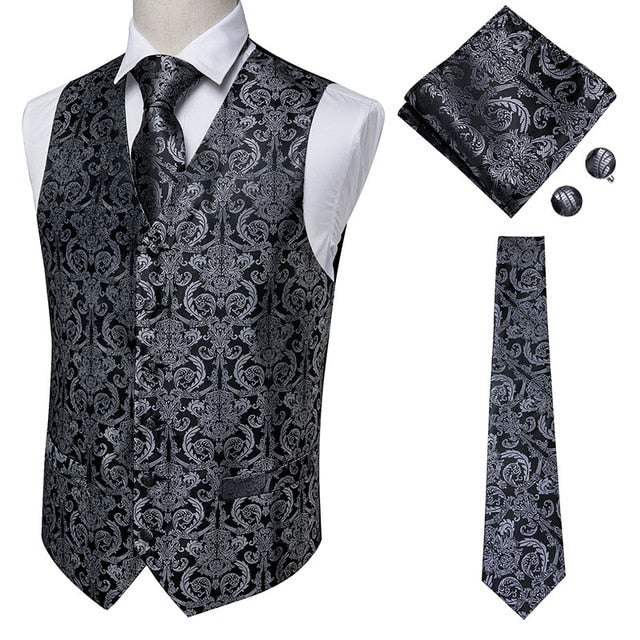 Set of four navy paisley silk dress vests with jacquard pattern, including tie, cufflinks, and pocket square, men's accessories.