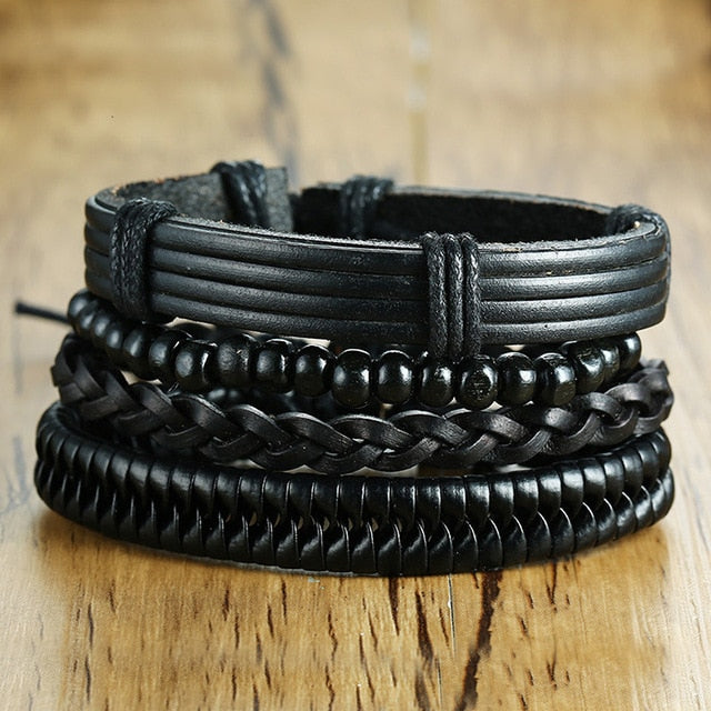 Set of four braided leather bracelets with wood beads, life tree rudder charm, and tribal style for men.