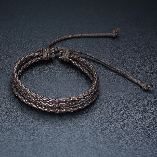 Four braided leather bracelets with wood beads, life tree charms, and ethnic tribal design for men, crafted by The Clothing Company Sydney.