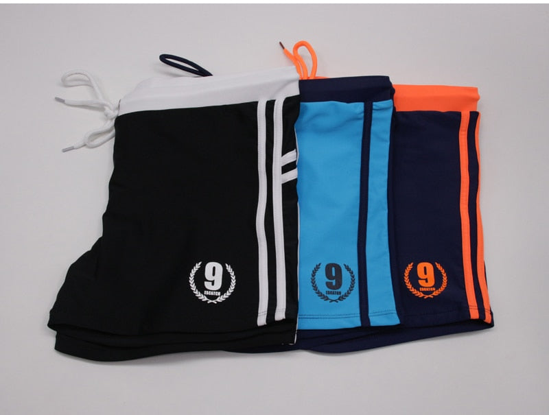 Men's breathable swim trunks by The Clothing Company Sydney, featuring quick-dry fabric and a comfortable boxer brief style for beachwear.