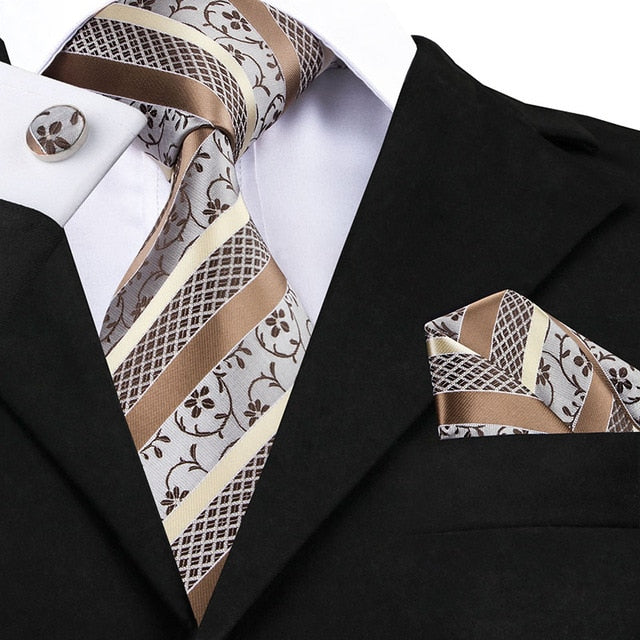 Set of men's accessories including a classic blue and black striped silk tie, pocket square, and cufflinks for wedding or formal wear.