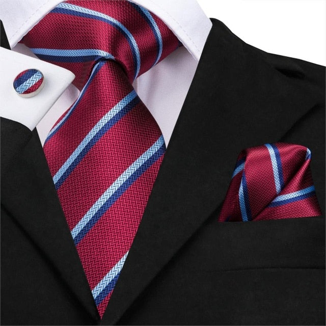 Set of men's accessories including a blue and black striped silk necktie, pocket square, and cufflinks from The Clothing Company Sydney