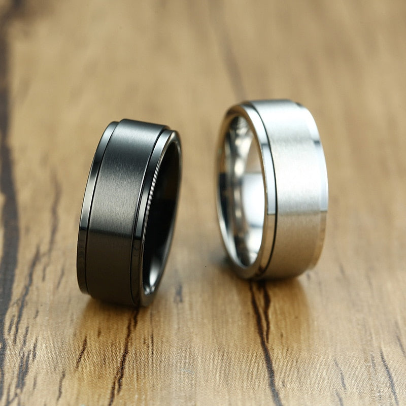 Stainless steel spinner ring with 6/8mm band, stress relief design, worn as casual jewelry for men and women.