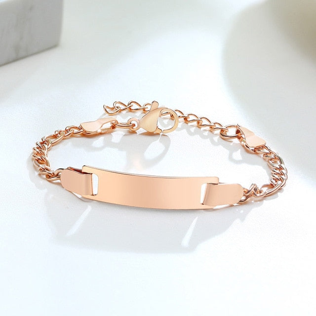 Personalized gold-tone stainless steel baby name bracelet with adjustable band, featuring custom engraved name.