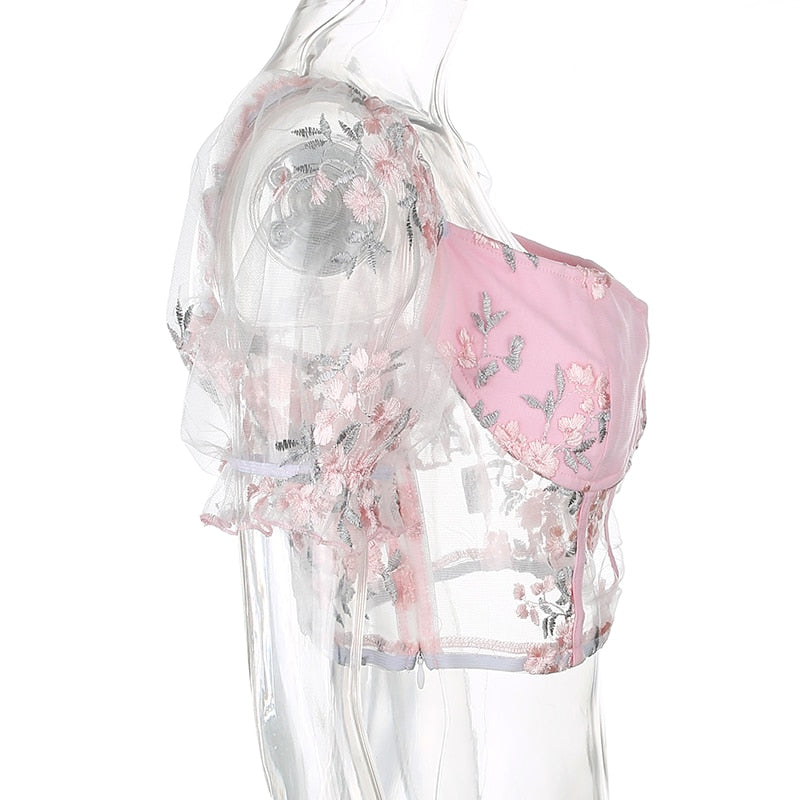 Pink mesh embroidered cropped bustier top with square neck, puff sleeves, and transparent fabric, perfect for summer style.