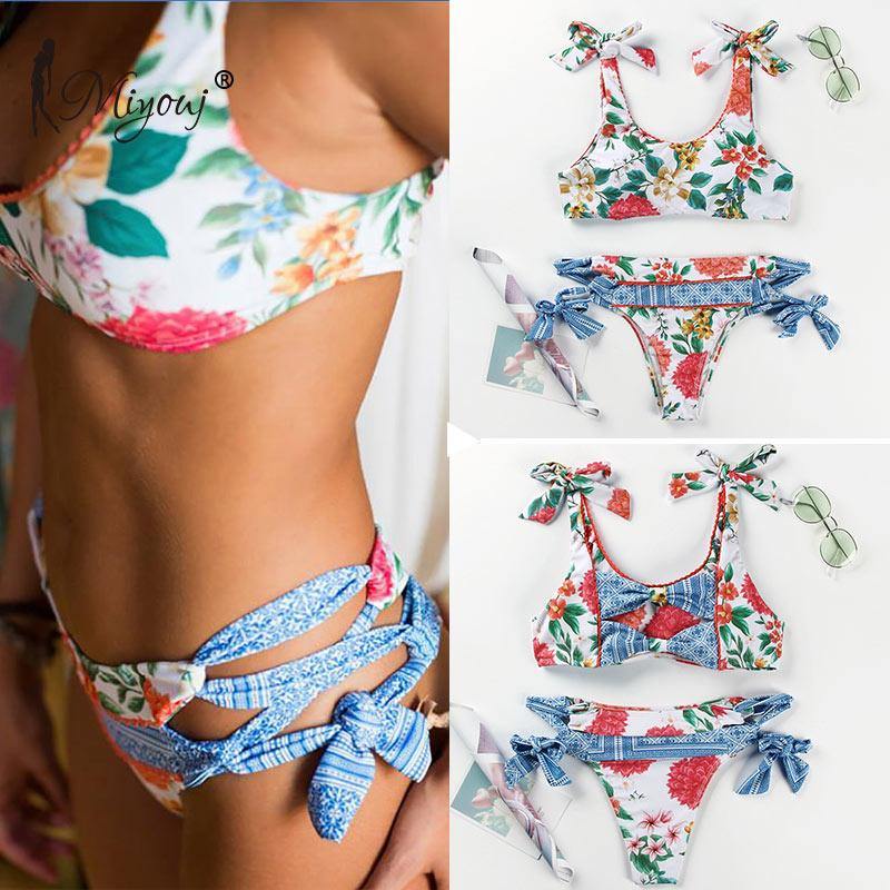 Deep V neck floral print bikini set with bow detail from The Clothing Company Sydney, featuring lace-up design and swimsuit style.