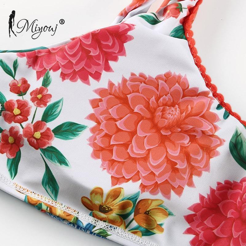 Deep V neck floral print bikini swimsuit with bow and lace-up design by The Clothing Company Sydney, displayed on a model.