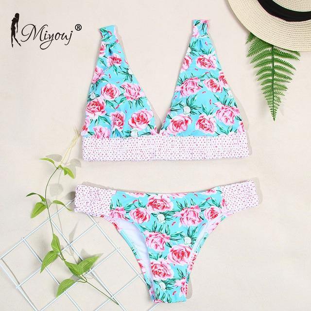 Deep V neck floral print bikini from The Clothing Company Sydney featuring a bow and lace-up design, perfect for swimwear.