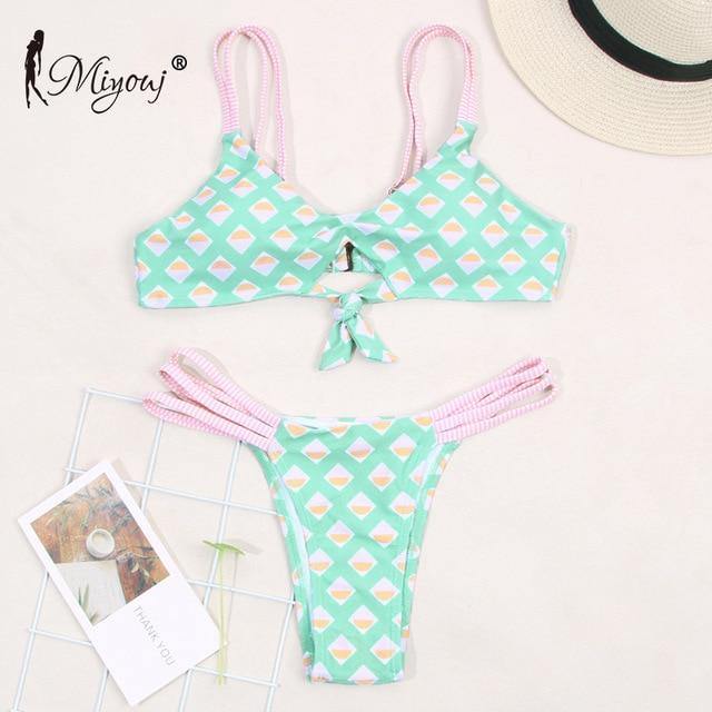 Deep V neck floral print bikini swimsuit with bow detail and lace-up design from The Clothing Company Sydney.