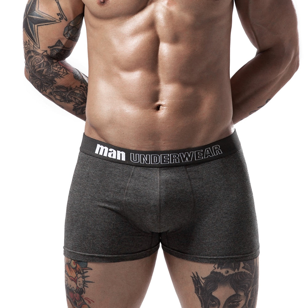 Four pairs of men's boxer briefs from The Clothing Company Sydney, featuring breathable cotton fabric, solid colors, and flexible fit.