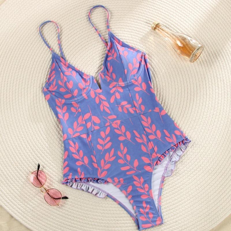 Purple and black floral V-neck monokini swimsuit with ruffles, one-piece design by The Clothing Company Sydney.
