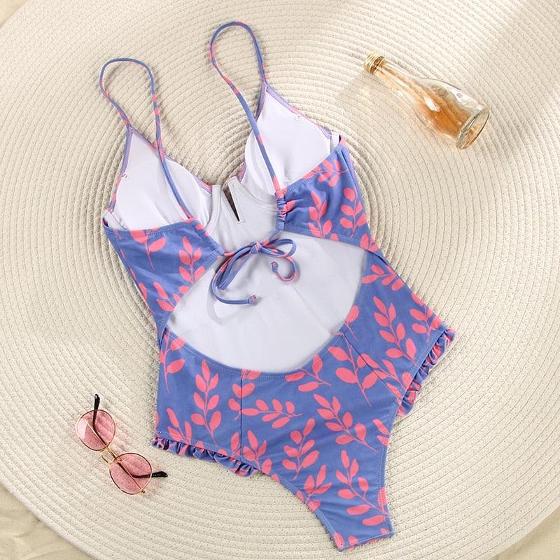 Purple and black floral one-piece swimsuit with V neck, ruffles, and monokini style from The Clothing Company Sydney.