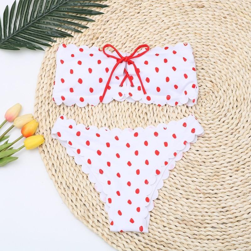 Polka dot two-piece swimsuit by The Clothing Company Sydney featuring floral side accents, push-up style, ideal for beach or pool.