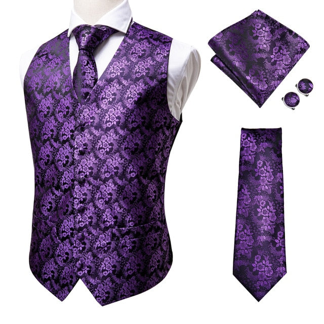 Set of four navy paisley silk dress vests with jacquard pattern, including matching tie, cufflinks, pocket square, and waistcoat accessories.