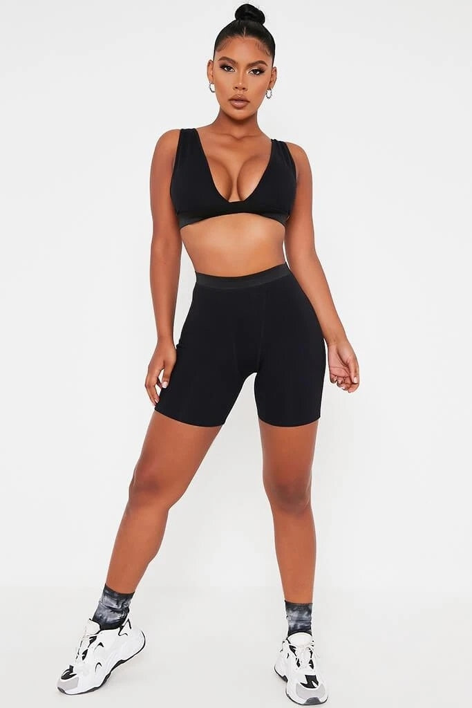 Khaki 2-piece sports set with V-neck crop top and biker shorts from The Clothing Company Sydney, sleeveless and backless for active wear.