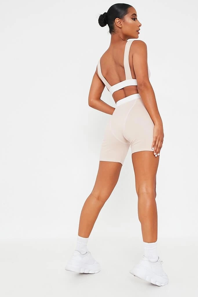 Khaki 2-piece fitness set by The Clothing Company Sydney with v-neck sleeveless crop top and biker shorts, backless design.