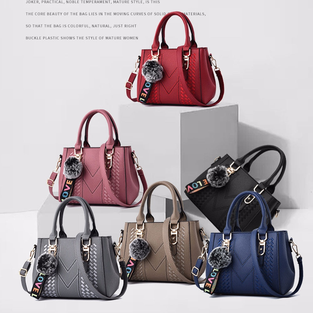 Embroidery handbag with fur ball detail, designer PU leather, shoulder crossbody style, suitable for office or casual use.