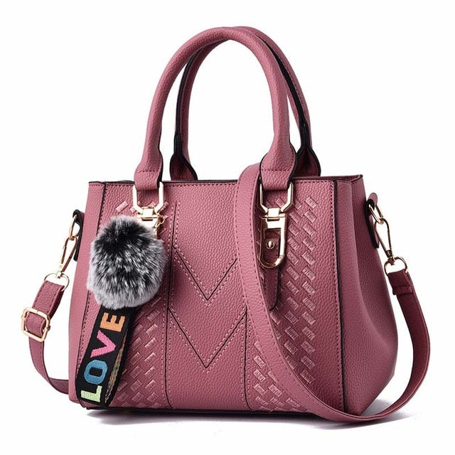 Embroidery handbag with fur ball accents, PU leather shoulder crossbody bag, stylish tote for women by The Clothing Company Sydney.