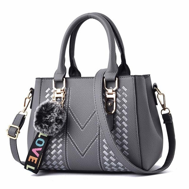 Embroidery handbag with fur ball, PU leather shoulder bag with crossbody strap, stylish tote for women by The Clothing Company Sydney.