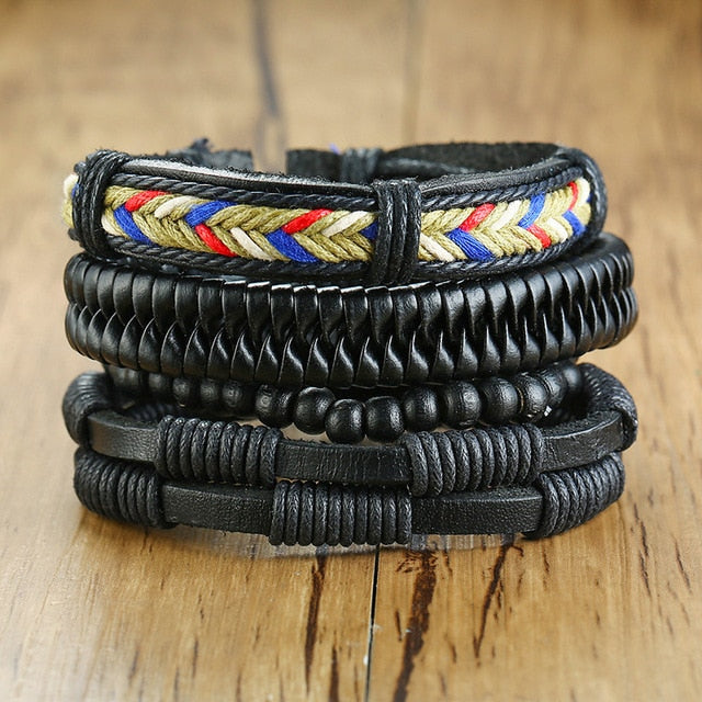 Four braided leather bracelets with wood beads, life tree rudder charm, and tribal style designs for men.