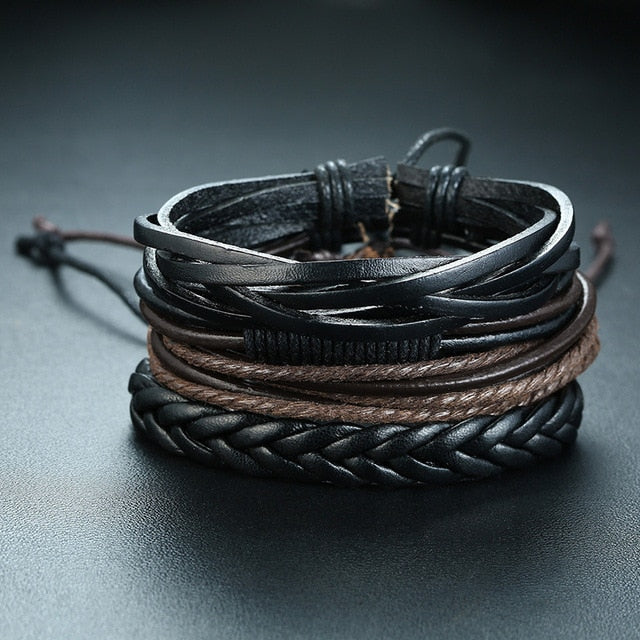 Set of four braided leather bracelets for men with wood beads, tribal charms, and vintage-style designs.